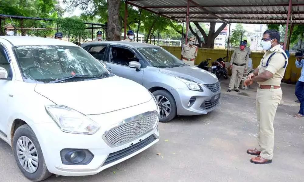 Superintendent of Police K K N Anburajan inspecting the seized cars and land documents from the interstate house breakings gang, in Kadapa on Thursday