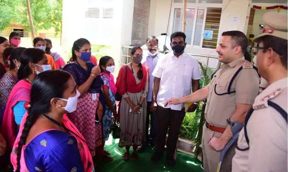 SP Kaushal interacting with victims of stamps and fake challans scam at Mandavalli village