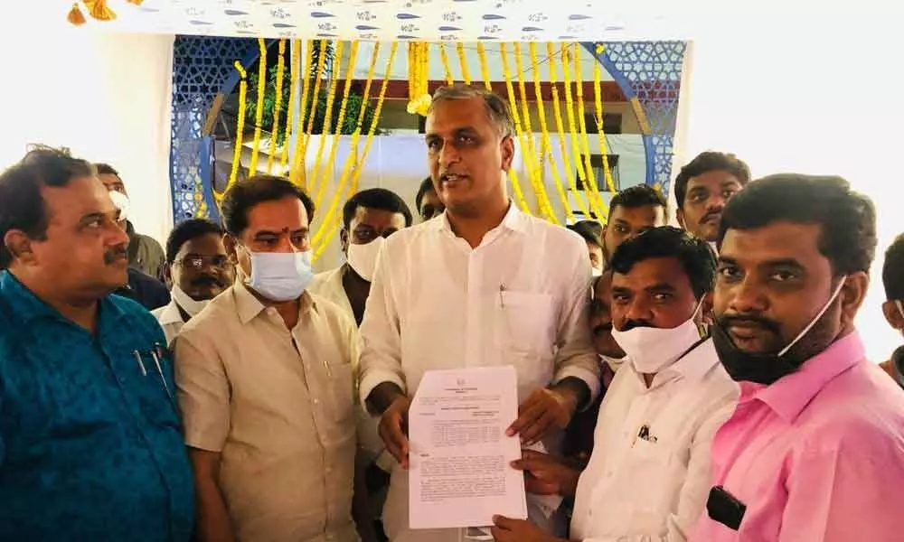 Finance Minister T Harish Rao releasing the GO copy of the Pay Revision Commission (PRC) awarded to  university employees, at Kakatiya University in Warangal on Thursday