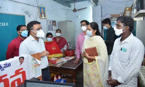 District Collector Vivek Yadav, Joint Collectors AS Dinesh Kumar, K Sridhar Reddy with the employees appointed on compassionate grounds in Guntur on Wednesday