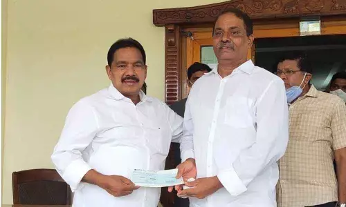 Minister Pinipe Viswaroop handing over cheque to a patient in Amalapuram on Thursday