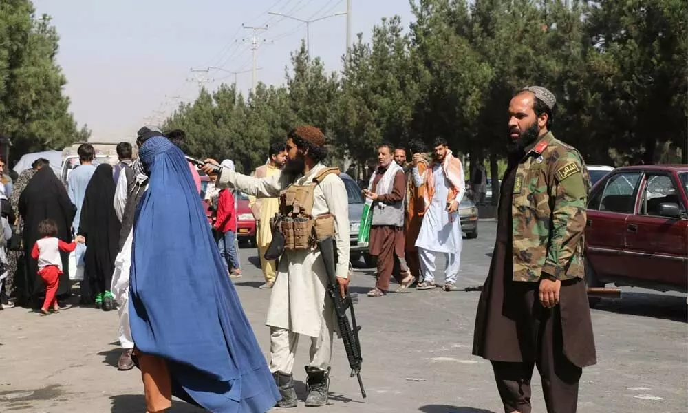 Taliban fighters stand guard outside the airport after Thursdays deadly attacks outside the airport in Kabul on Friday