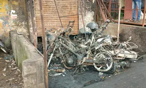 Gutted two-wheelers in front of a mechanic shed in Visakhapatnam