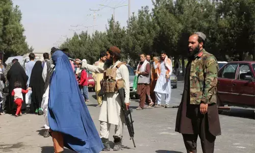 Taliban fighters stand guard outside the airport after Thursdays deadly attacks outside the airport in Kabul on Friday