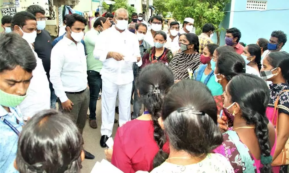 Vijayawada Central MLA Malladi Vishnu and Municipal Commissioner Prasanna Venkatesh speaking to the residents of Devi Nagar in Vijayawada on Saturday
