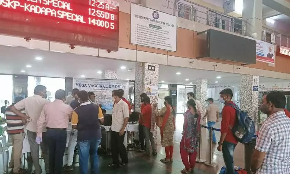 People waiting in queue for their turn during the vaccination drive held at Visakhapatnam railway station on Saturday