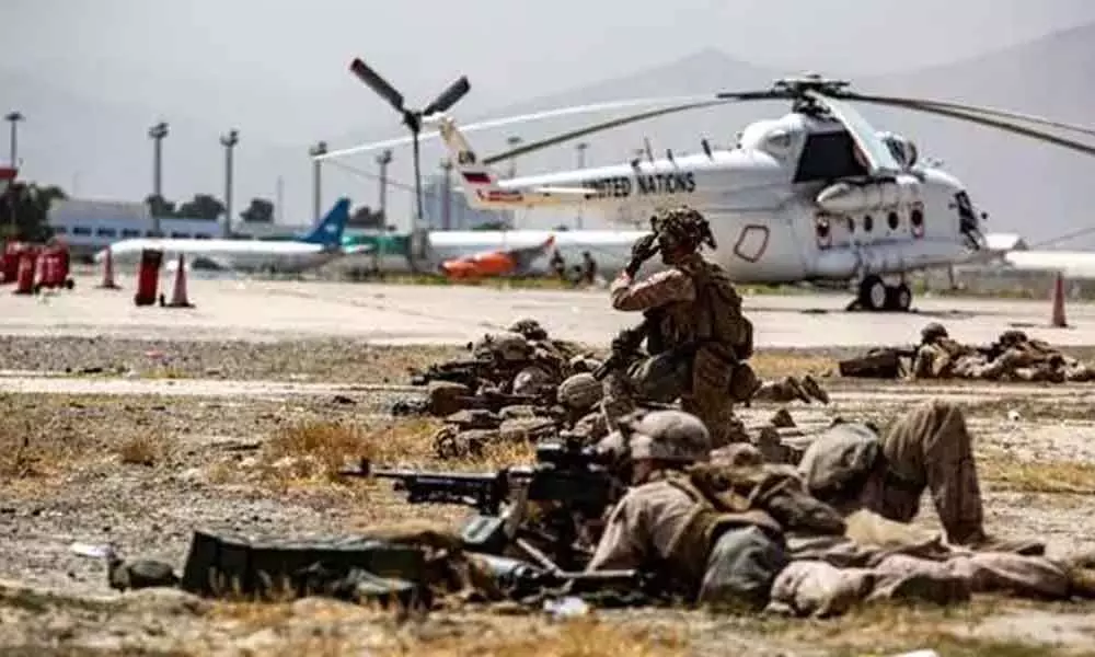 US Marines keep watch during an evacuation at Hamid Karzai International Airport, Kabul, Afghanistan. (REUTERS)