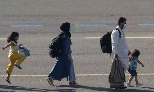 An Afghan girl walks on the tarmac of the Melsbroek military airport in Belgium (Image Courtesy: Reuters journalist Johanna Geron)