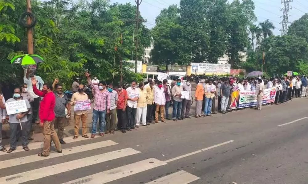 Employees, representatives of different political parties and volunteers taking part in a human chain against the privatisation of VSP