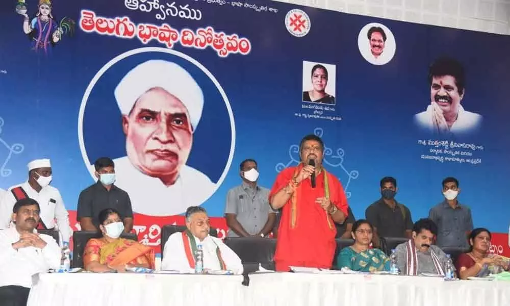 Tourism Minister M Srinivasa Rao speaking at the Telugu Language Day celebrations at the YVS Murthy Auditorium at AU in Visakhapatnam on Sunday.