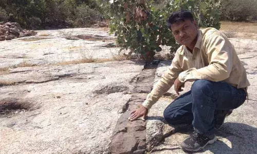 R Ratnakar Reddy, an archaeological enthusiast, showing the dyke at Veldanda village in Jangaon district
