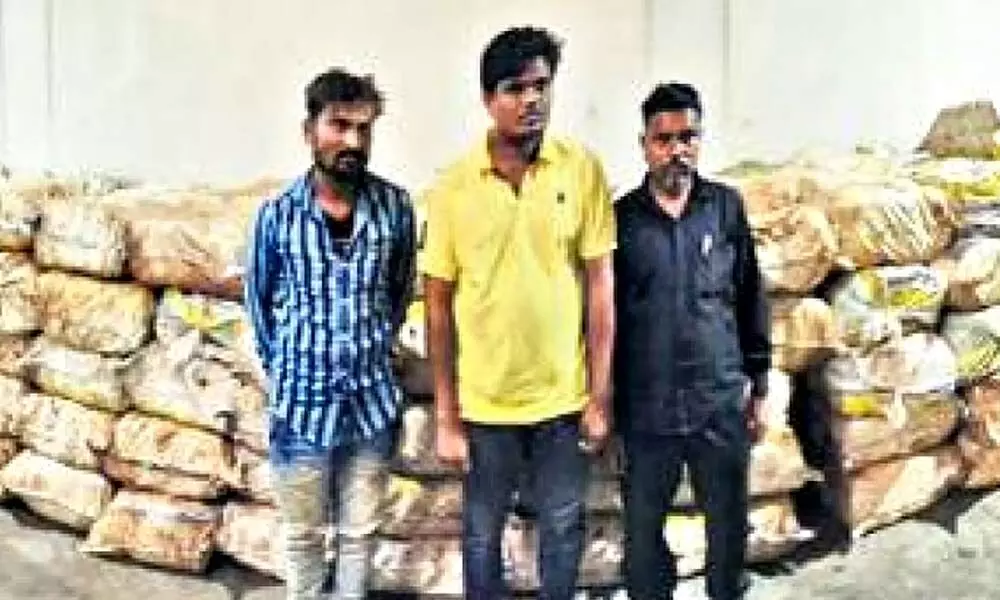 The three accused with the recovered haul of marijuana. (Photo | Express)