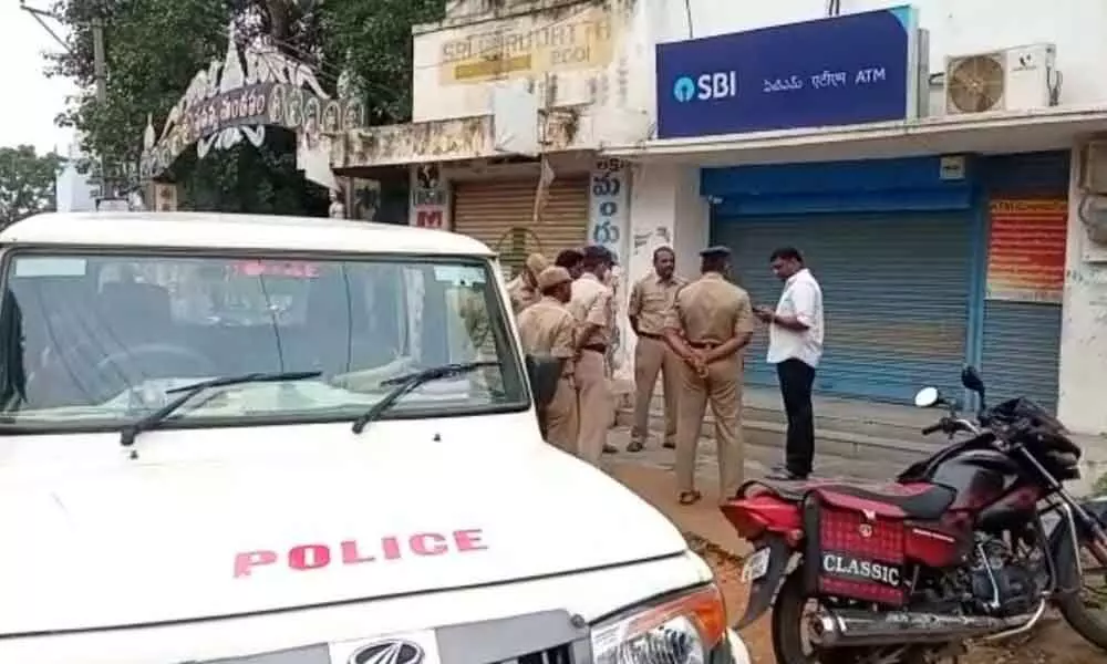 Police inspecting the scene of offence where two ATMs were robbed at Dhone in Kurnool district on Monday