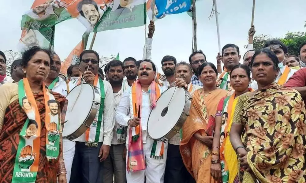 Congress leader V Shankar beating a drum at Dalita Girijana Dandora Sabha in Santapur village on Monday