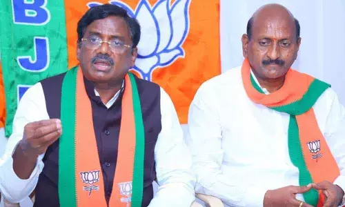 BJP leader Vivek Venkata Swamy addressing a press conference in Huzurabad on Monday