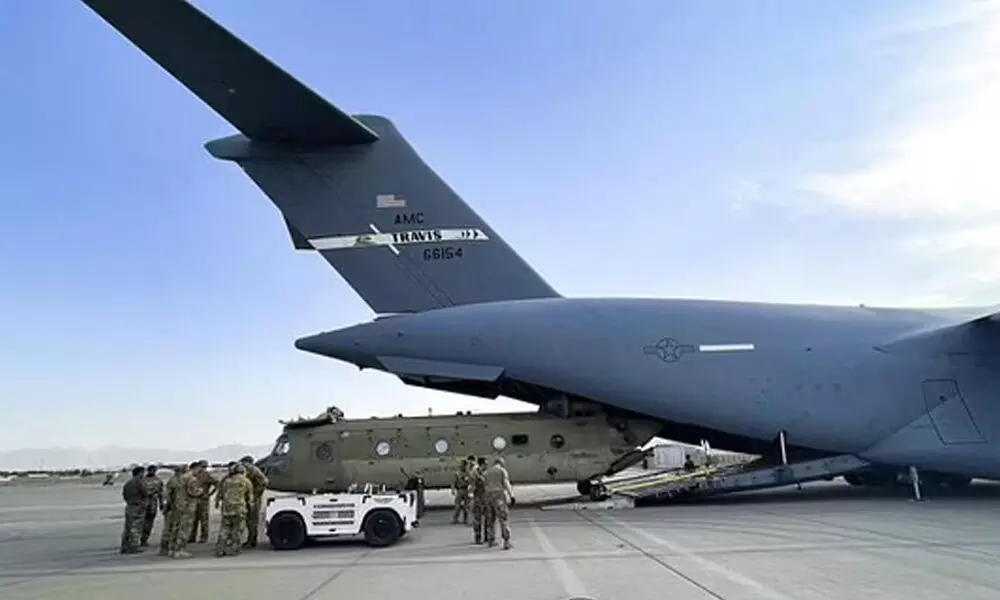 A CH-47 Chinook from the 82nd Combat Aviation Brigade, 82nd Airborne Division is loaded onto a U.S. Air Force C-17 Globemaster III at Hamid Karzai International Airport. (Photo | AP)