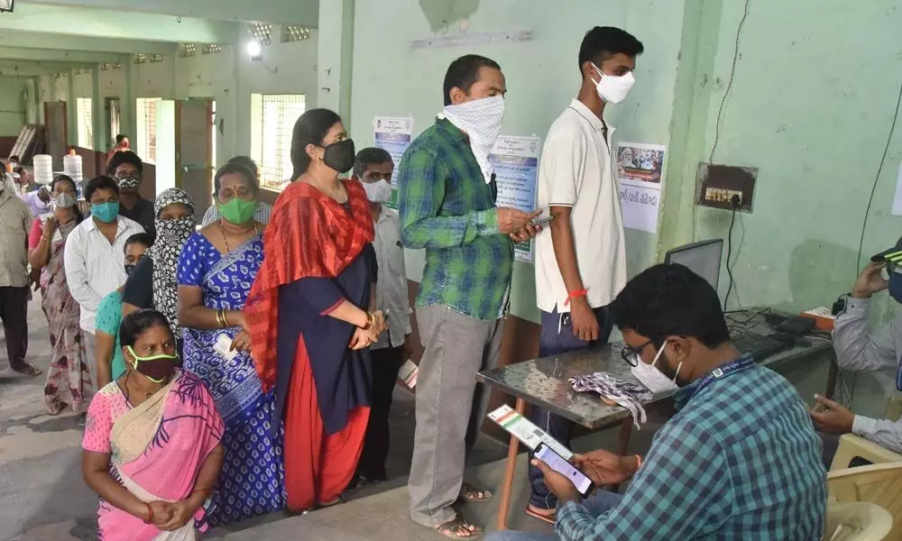 People waiting in queues for registering names at Covid vaccination centre in Vijayawada on Tuesday