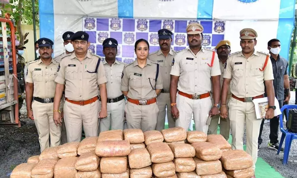 The police officials with seized ganja in Inkollu on Tuesday