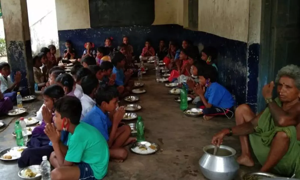 Students having midday meal at Ponnada primary school in Etcherla mandal