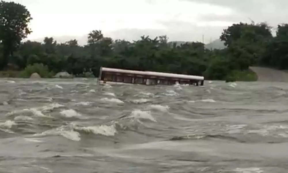 An RTC bus stranded in a stream at Gambhiraopet in Sircilla district washed away by the floodwaters on Tuesday