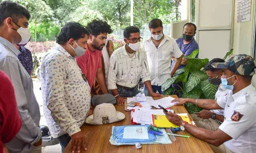 Police collect the documents of family members & relatives who came to collect the bodies of the Audi car crash victims