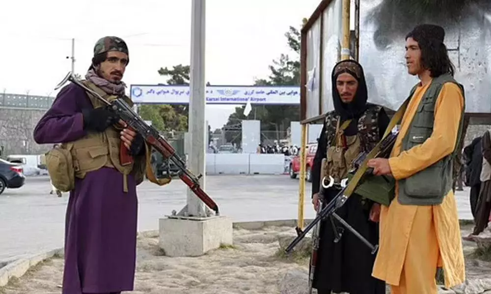 Taliban fighters stand guard in front of the Hamid Karzai International Airport after the U.S. withdrawal in Kabul. (Photo | AP)