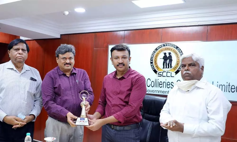 SCCL chairman and managing director N Sridhar congratulating director  D Satyanarayana Rao at a meeting in Hyderabad on Thursday