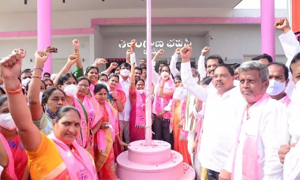 TRS leaders and workers participating in the party flag hoisting programme at the district party office in Khammam on Thursday