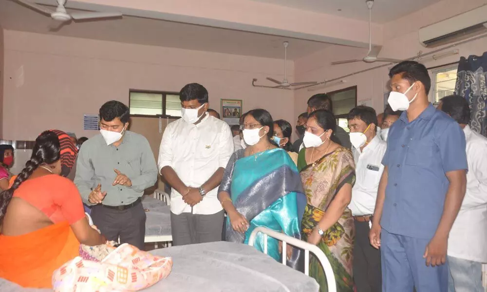 District Collector A Mallikarjuna interacting with a patient at Anakapalle area hospital in Visakhapatnam on Thursday