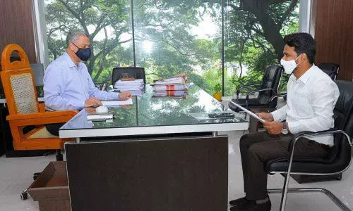 VMC Commissioner Prasanna Venkatesh submitting a representation to the MD, APSRTC, Dwaraka Tirumala in Vijayawada on Thursday