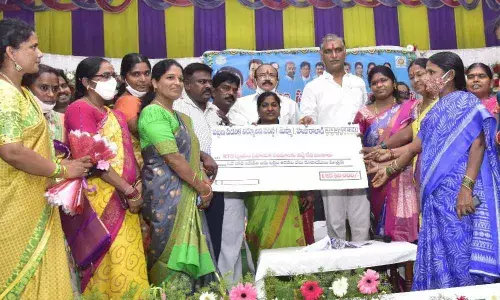 Minister T Harish Rao disburing interest-free loans to women associations in Huzurabad on Saturday