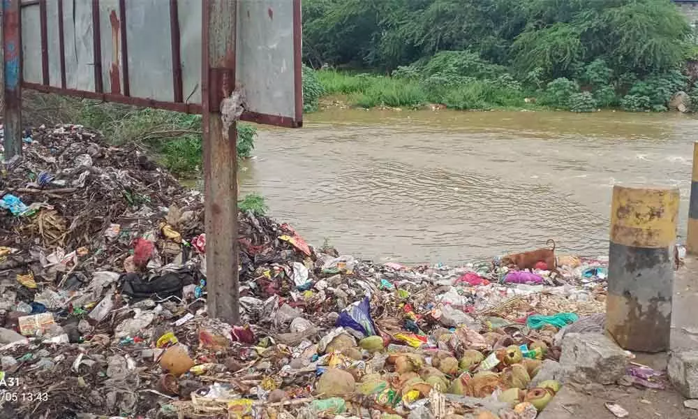 The garbage piled up at Swarnamukhi riverbed in Tiruchanoor