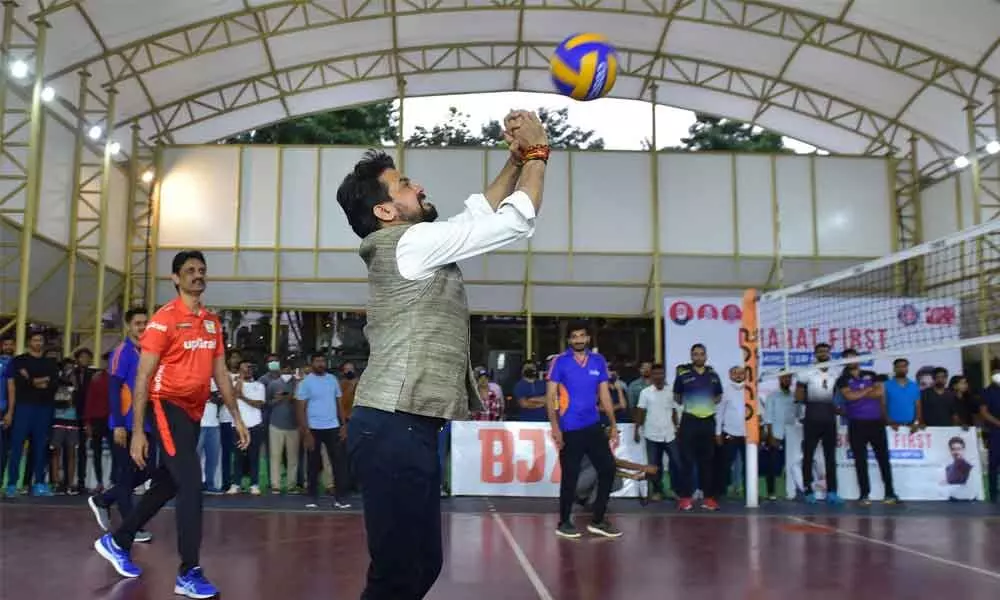 Union Sports Minister Anurag Thakur plays volleyball during an exhibition match in Bengaluru on Sunday
