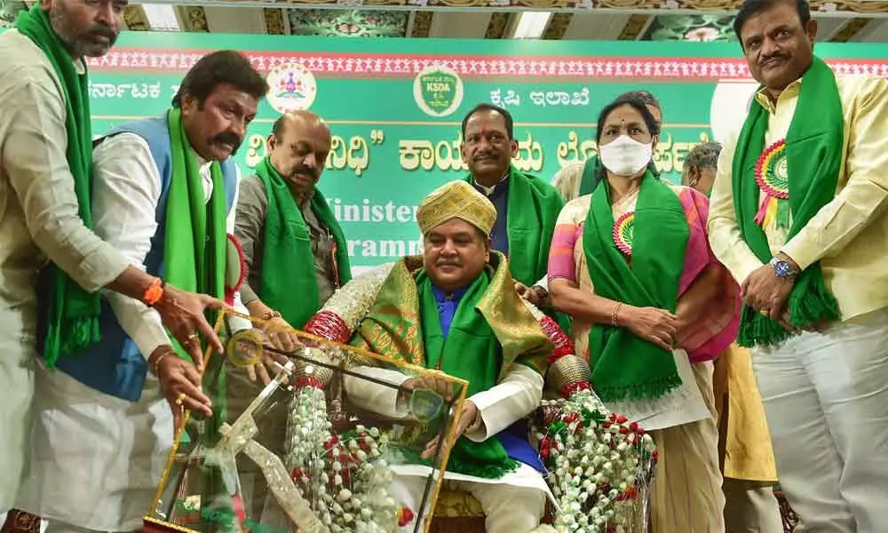 Union Agriculture Minister Narendra Singh Tomar being felicitated by Karnataka Agriculture Minister B C Patil as Chief Minister Basavaraj Bommai and Union Minister of State for Agriculture Shobha Karandlaje look on during the inauguration of the Chief Minister Raitha Vidya Nidhi programme at Vidhana Soudha in Bengaluru on Sunday