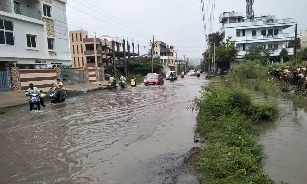 The flooded Ratnagiri Nagar road at Palakaluru in Guntur on Sunday