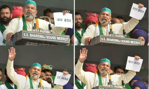 Combo pics: Bharatiya Kisan Union spokesperson Rakesh Tikait holds placards during a Kisan Mahapanchayat in Muzaffarnagar on Sunday