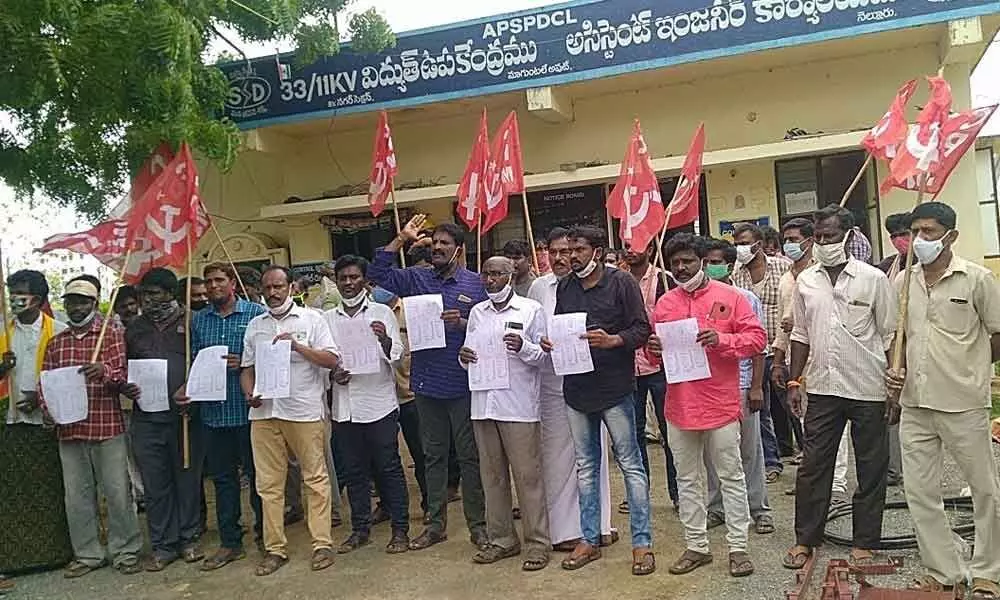 CPM leaders staging protest against true-up charges at the substation in Magunta Layout in Nellore on Monday