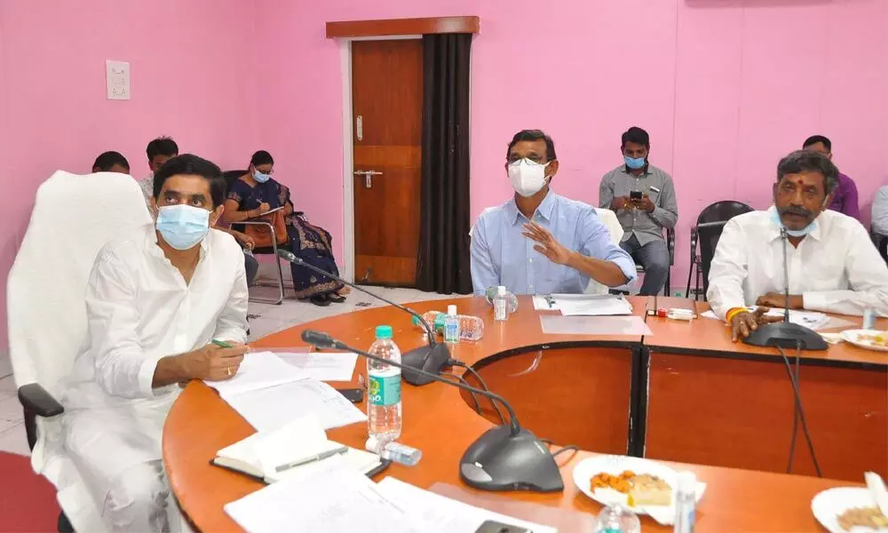 Finance Minister Buggana Rajendranath Reddy holds a reviewing meeting with the officials concerned on progress of development works at state guest house in Kurnool on Tuesday.