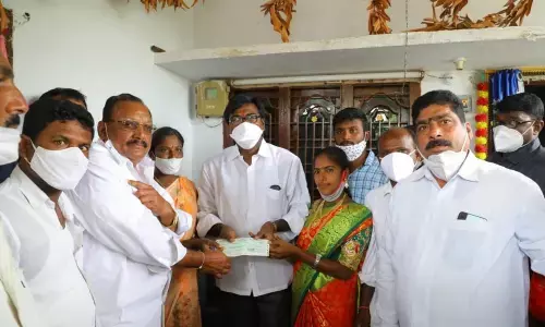Minister for Transport Puvvada Ajay Kumar distributing Kalyana Lakshmi cheques at door-steps in Raghunadhapalem mandal of Khammam district on Tuesday