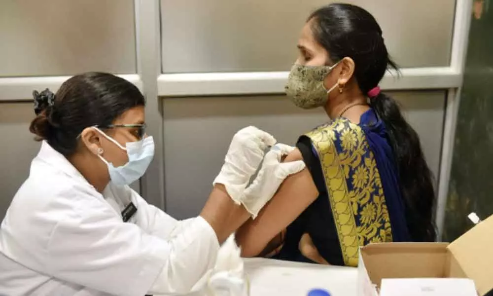 A medic administers Covid-19 vaccine dose to a woman at Civil Hospital in Lucknow on Thursday