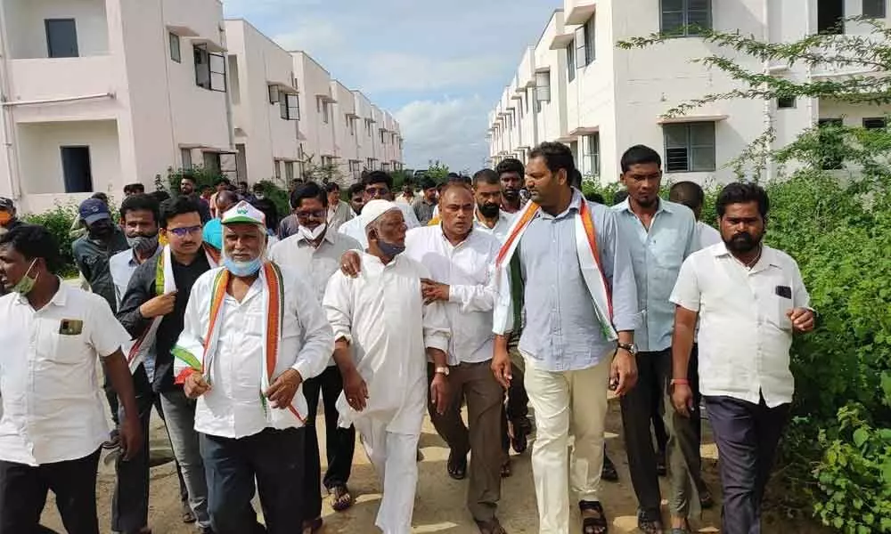 Congress Jadcherla constituency incharge Anirudh Reddy along with other Congress party leaders inspect the double bedroom houses at Yerraguta in Jadcherla on Saturday