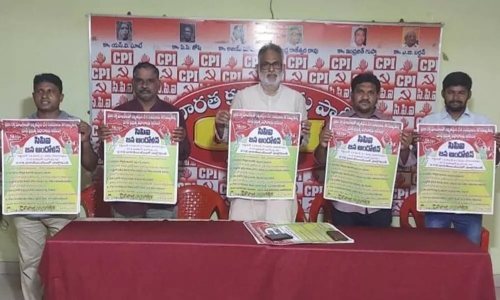 CPI leaders launching a poster at a programme in Visakhapatnam on Sunday