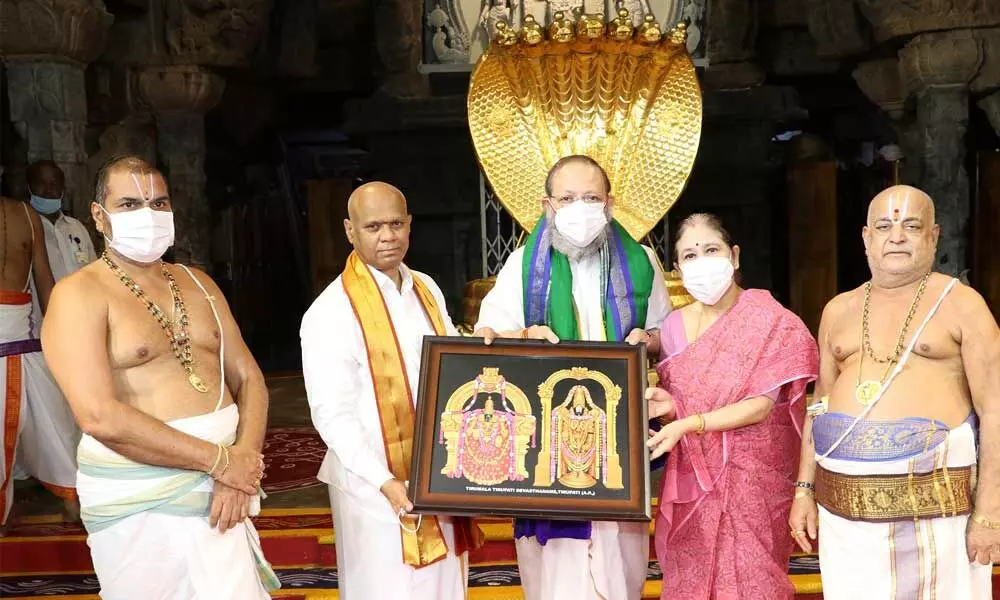 Additional EO A V Dharma Reddy presenting a portrait of Lord Venkateswara and Goddess Padmavathi to the Chief Justice of AP High Court Justice Arup Kumar Goswami at Tirumala on Sunday