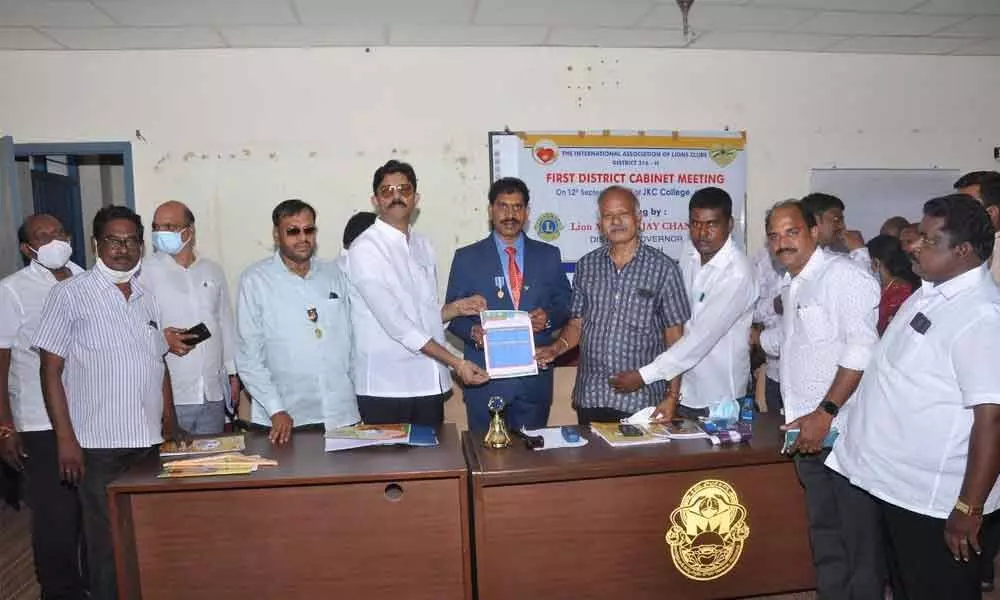 Lions Club 316H District Governor Vijay Chand handing over appointment orders to Sk Nyamatulla Basha and M Narasimha Rao in Guntur on Sunday