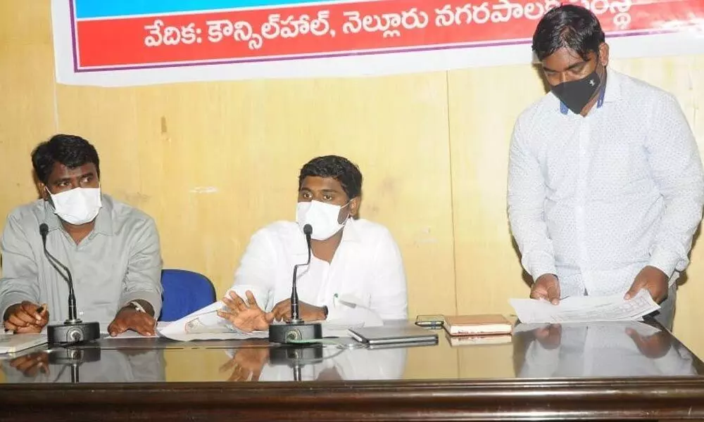 Municipal Commissioner K Dinesh Kumar interacting with officials in Nellore on Tuesday