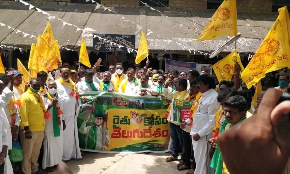TDP activists led by MLC K E Prabhakar staging a protest in front of the tahsildar’s office in Dhone on Tuesday