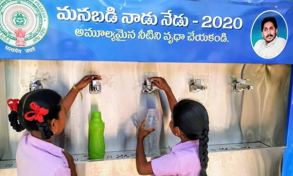 Students not able to fill their bottles with water as RO water system installation is pending at Municipal High School at Ram Nagar in Ongole
