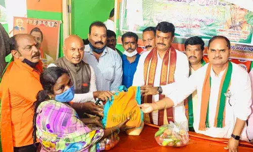 MLC PVN Madhav and other leaders distributing ration kits to poor people in Visakhapatnam on Friday