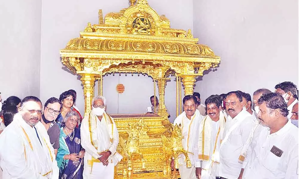Deputy Chief Minister K Narayana Swamy along with TTD Chairman Y V Subba Reddy handing over the golden chariot to Kanipakam temple officials on Saturday