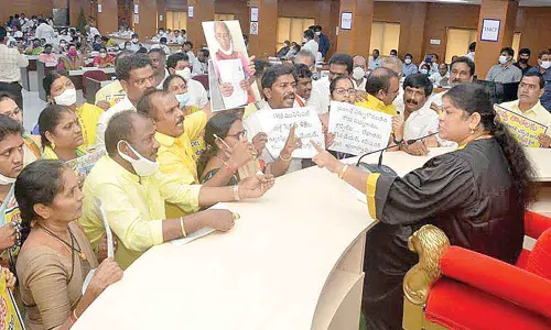 TDP leaders staging a protest near Mayor G Hari Venkata Kumari’s podium at the municipal council meeting in Visakhapatnam on Saturday